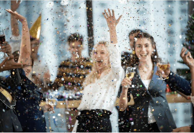 Business people celebrating an event with wine and confetti