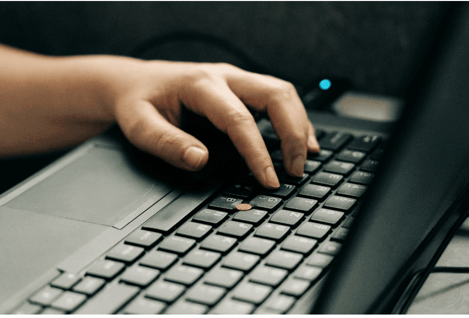 A close-up of someone using a laptop to find keywords for their business