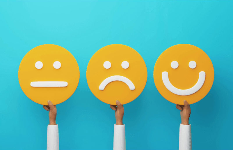 A graphic of three arms holding up three yellow faces, one neutral, one sad, and one happy