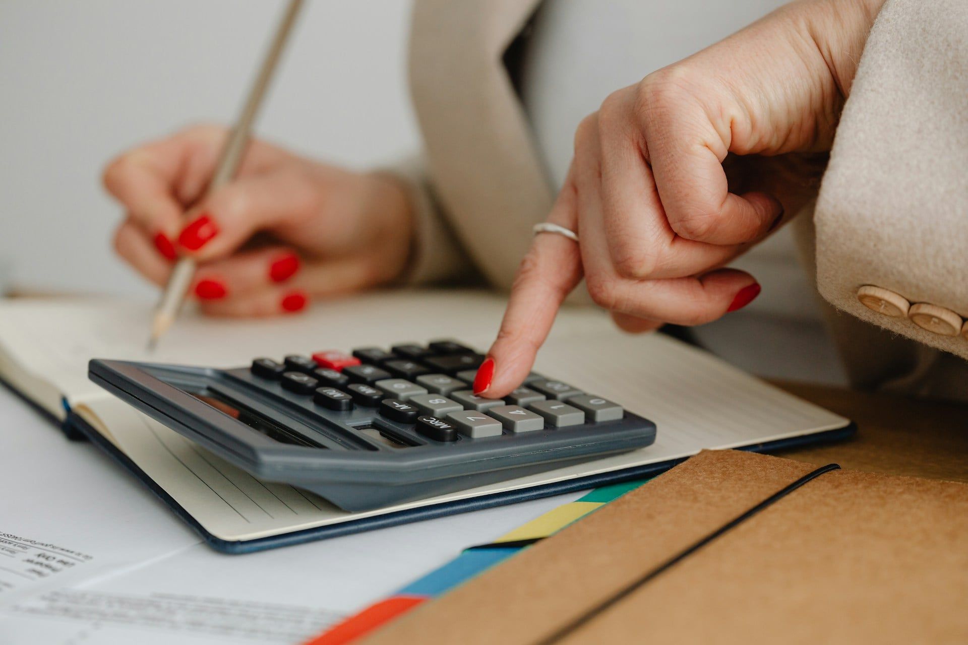 A close-up of a female business owner working out her website budget