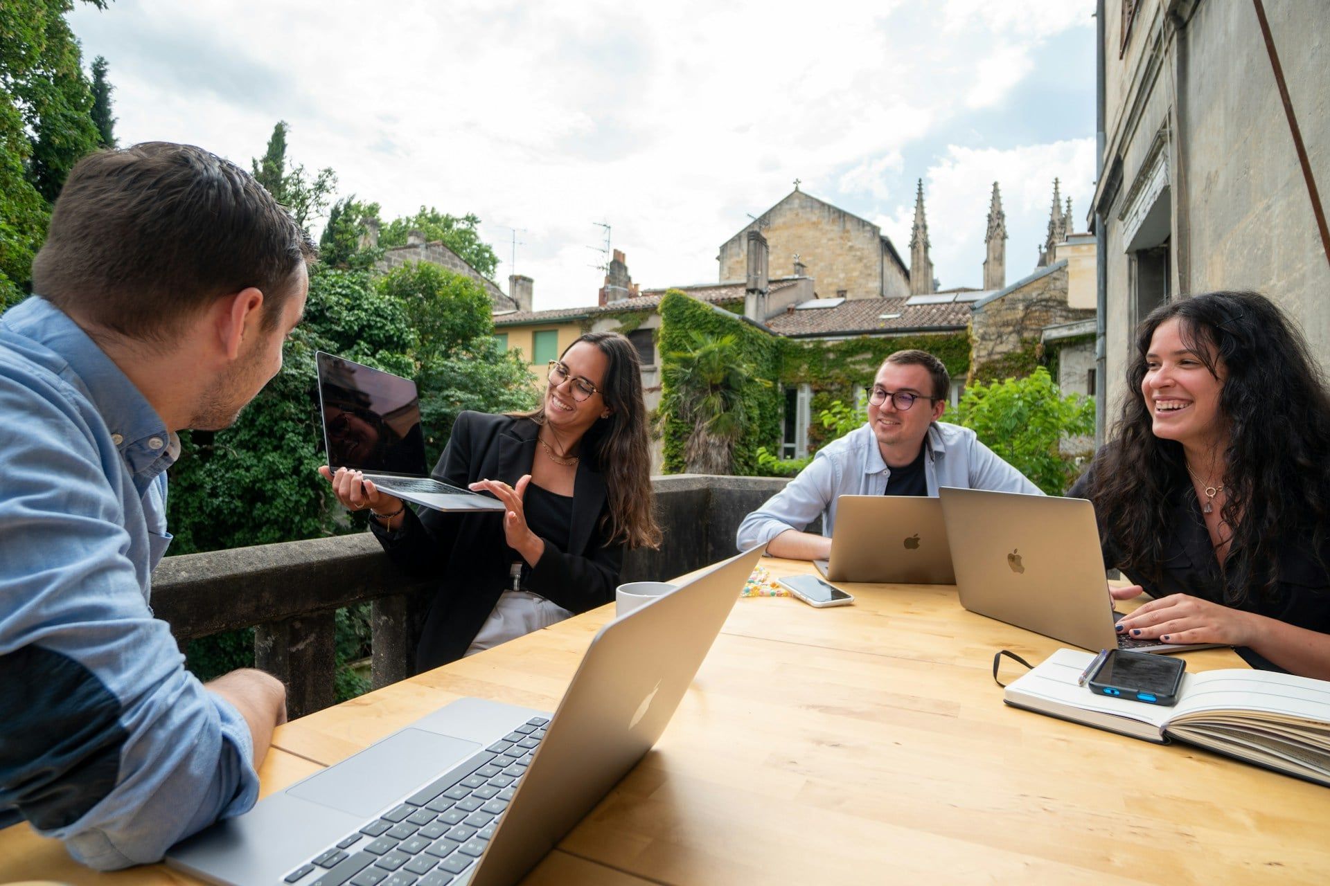A professional web design team sits outside showing off their new website design