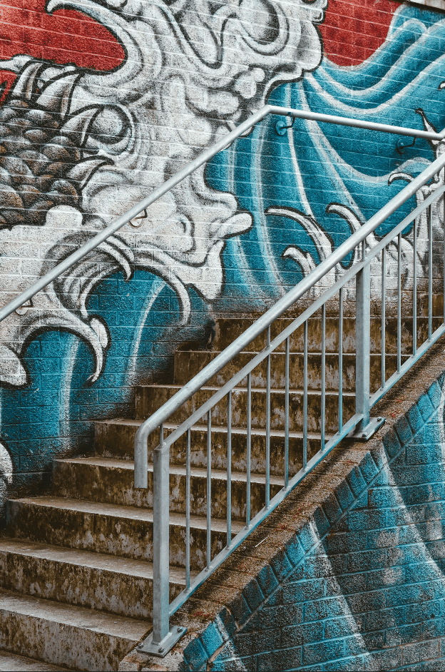 A walkway adorned with vibrant, colorful art covering the walls, creating a lively and inspiring atmosphere.