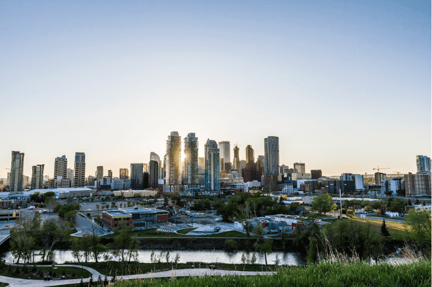 A panoramic view of a bustling city’s skyline, with high-rises and glowing windows.