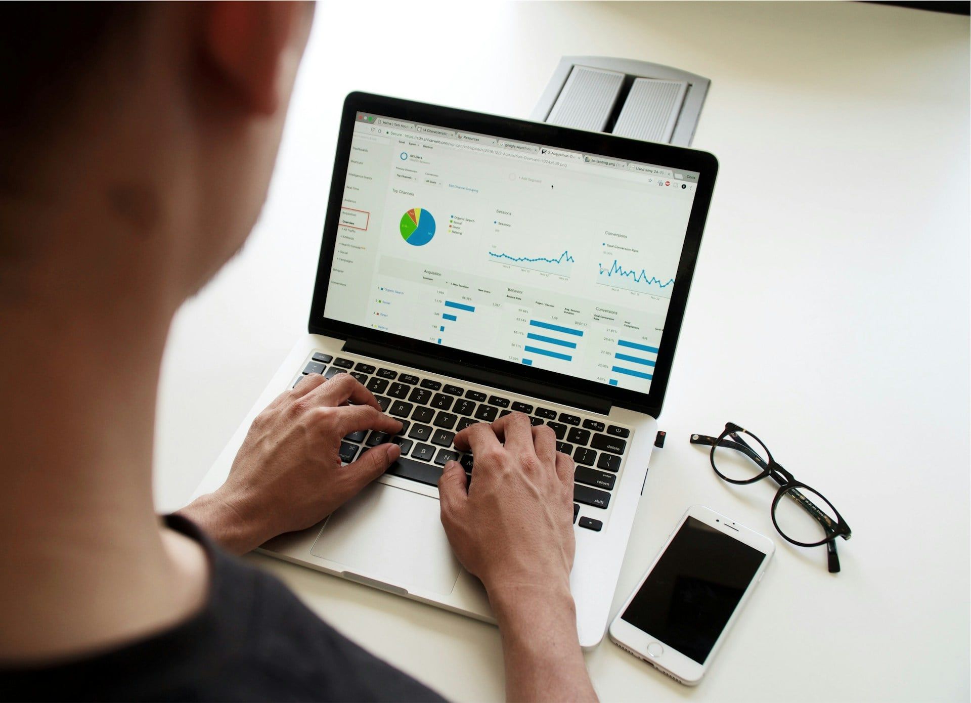 A webmaster looking through their website and user analytics on a laptop
