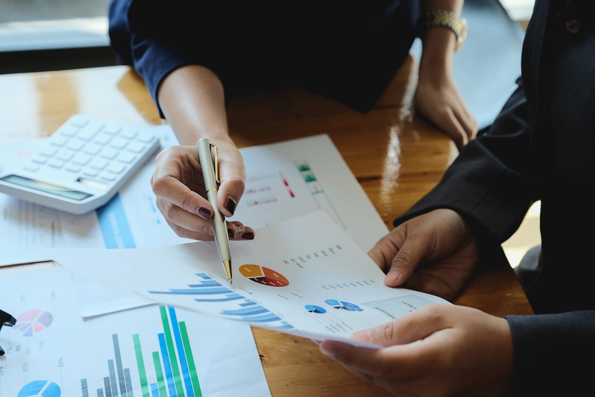 Two business owners at a desk looking through their website metrics