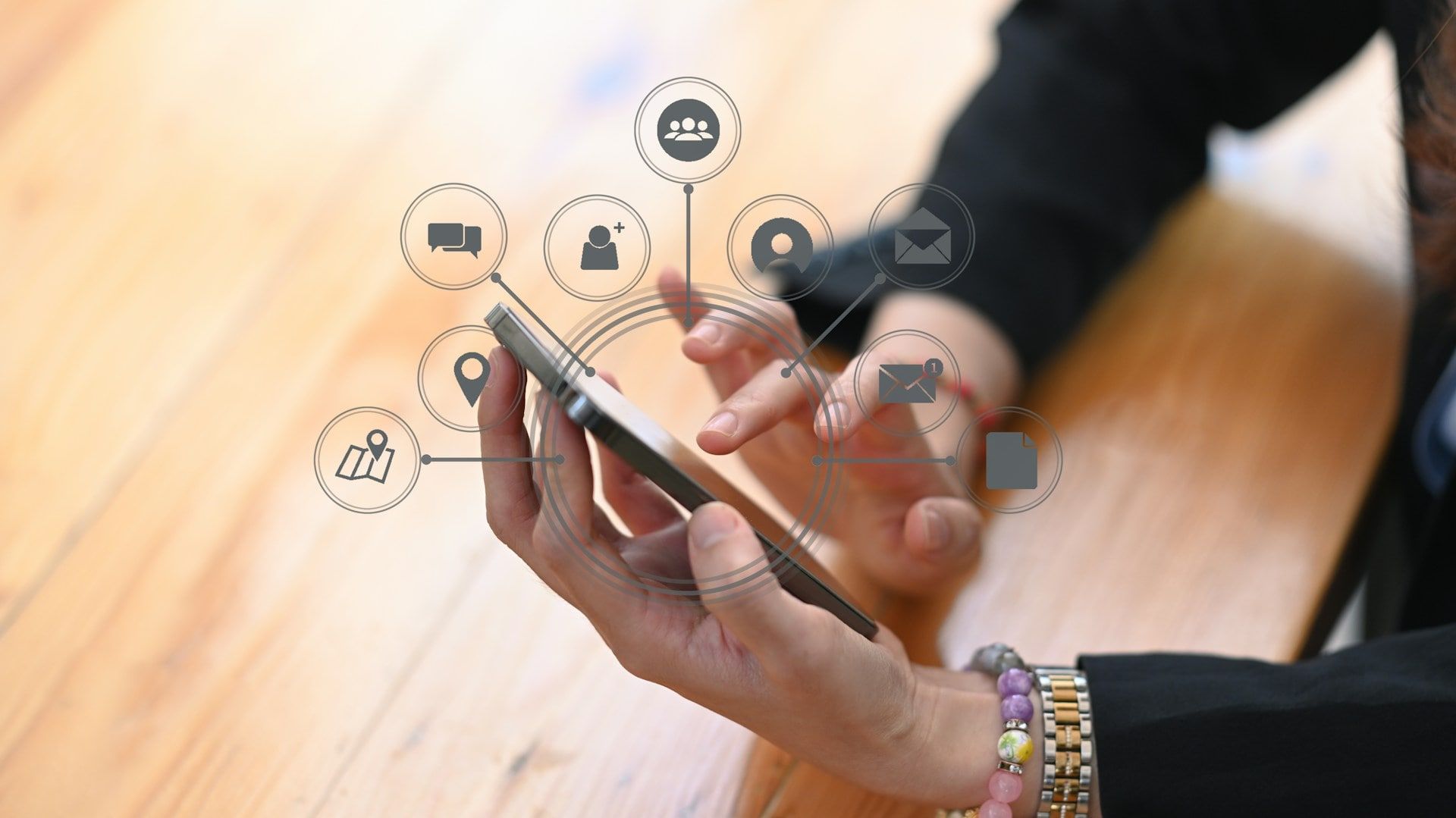 Someone using a smartphone with icons coming out of it, like messaging and maps