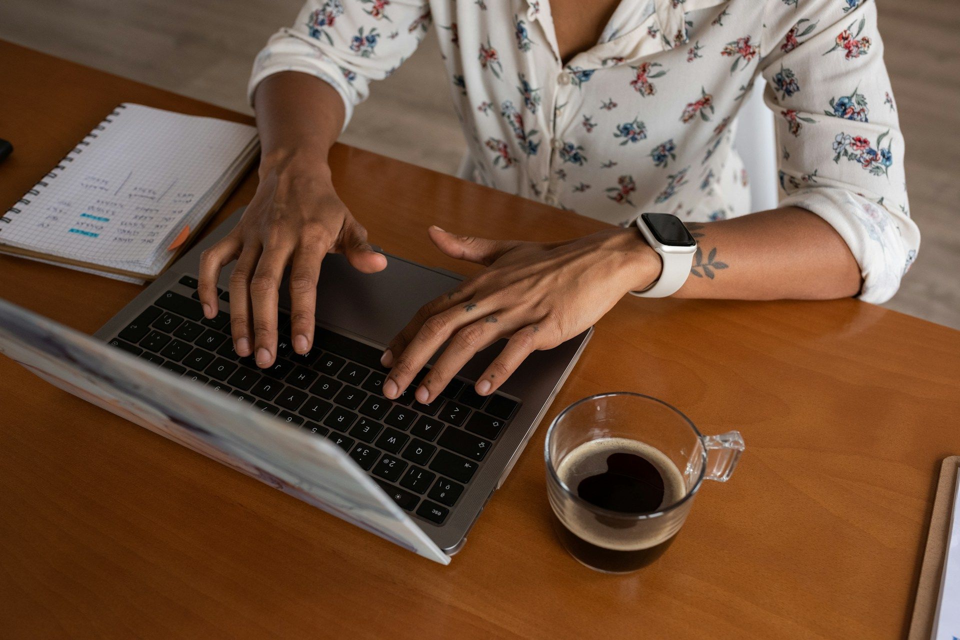 A close-up of a female business owner writing blog content on her laptop