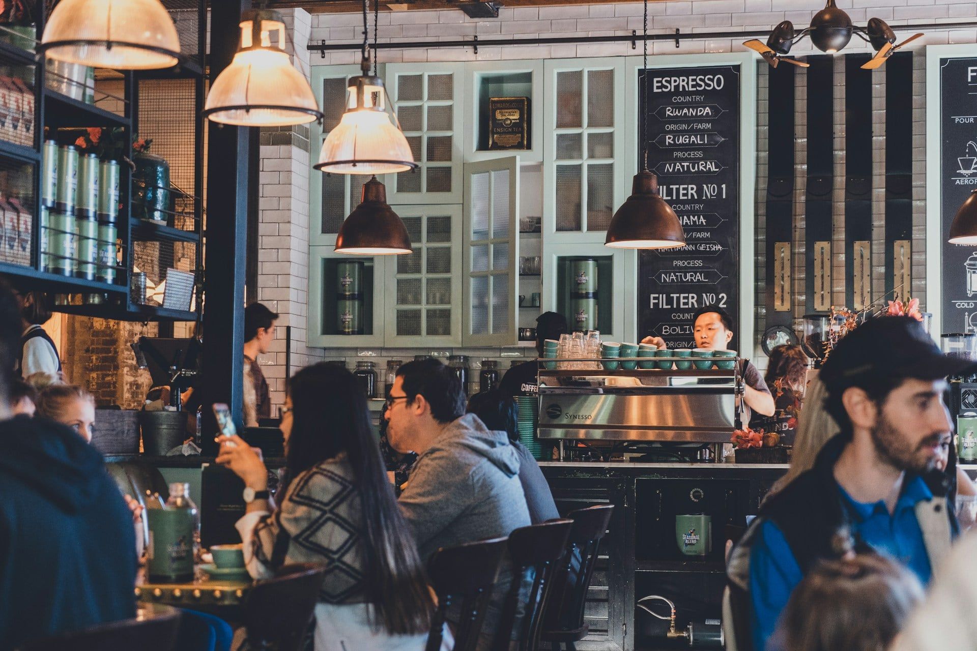 A local busy cafe serving customers at the peak of the day