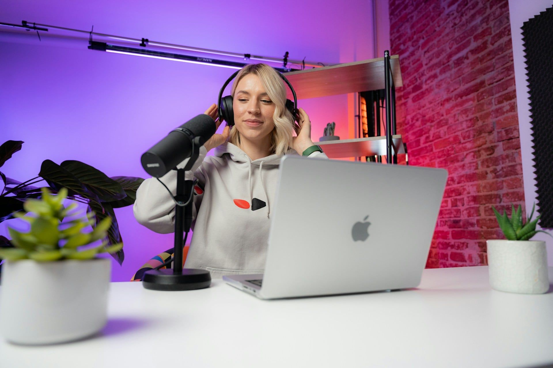 A female content creator puts on headphones ready to make content for her business