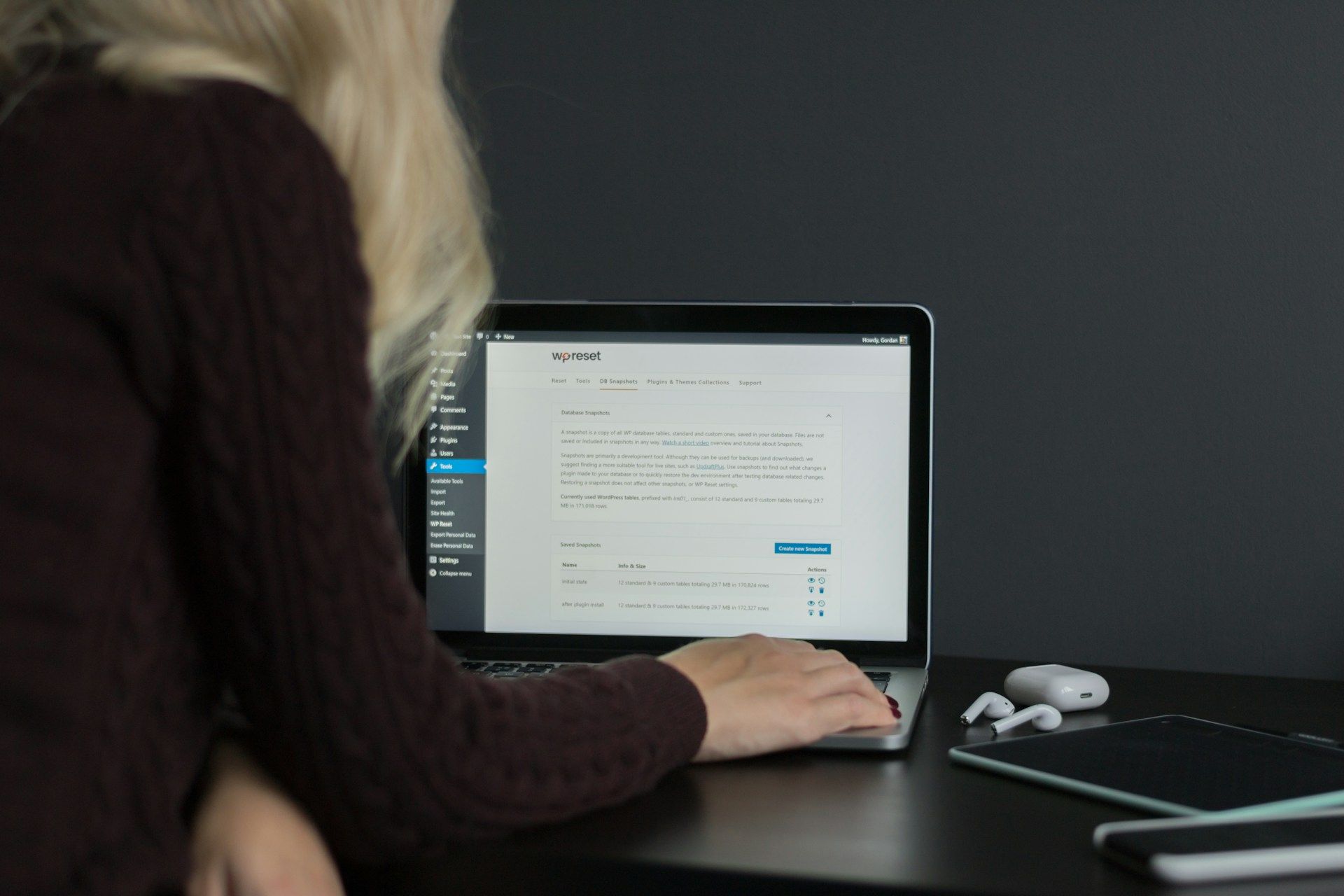 A female business owner sitting at her laptop working on Wordpress